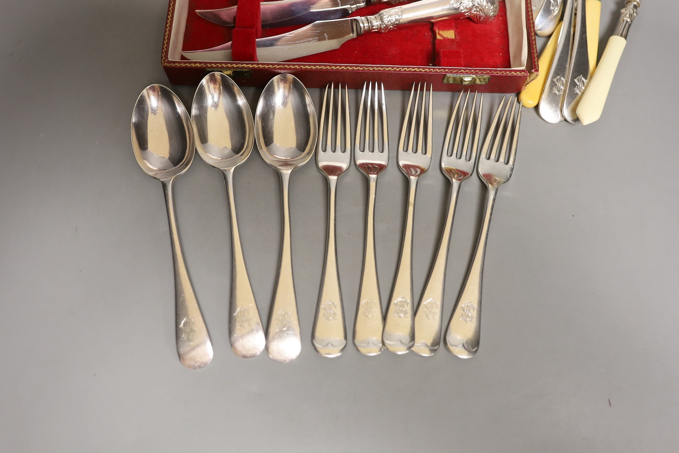 A cased set Garrard pistol handled steak knives, other plated cutlery and a plated mug